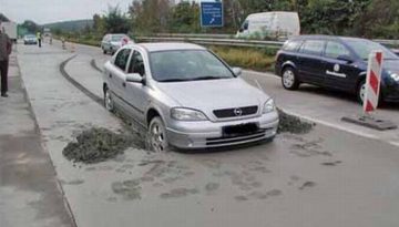 A German motorist got stuck in fresh concrete when he made way to a police car.