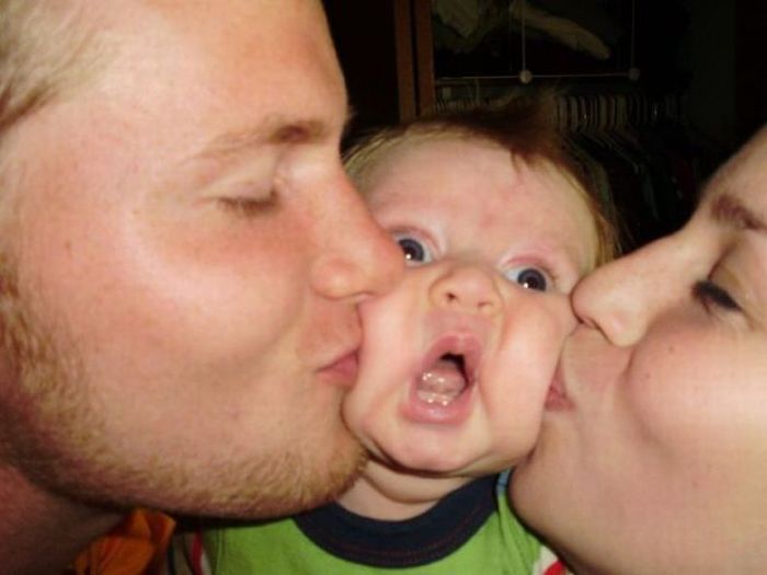 Couple Kissing Baby – 