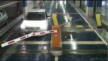 Woman Crashes into Parking Barrier