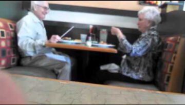 Senior Couple Goofing Around at a Restaurant
