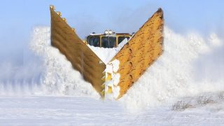 Trains Plowing Through Snowy Railway Tracks