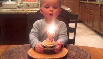Little Boy Tries His Best to Blow out His Birthday Candle